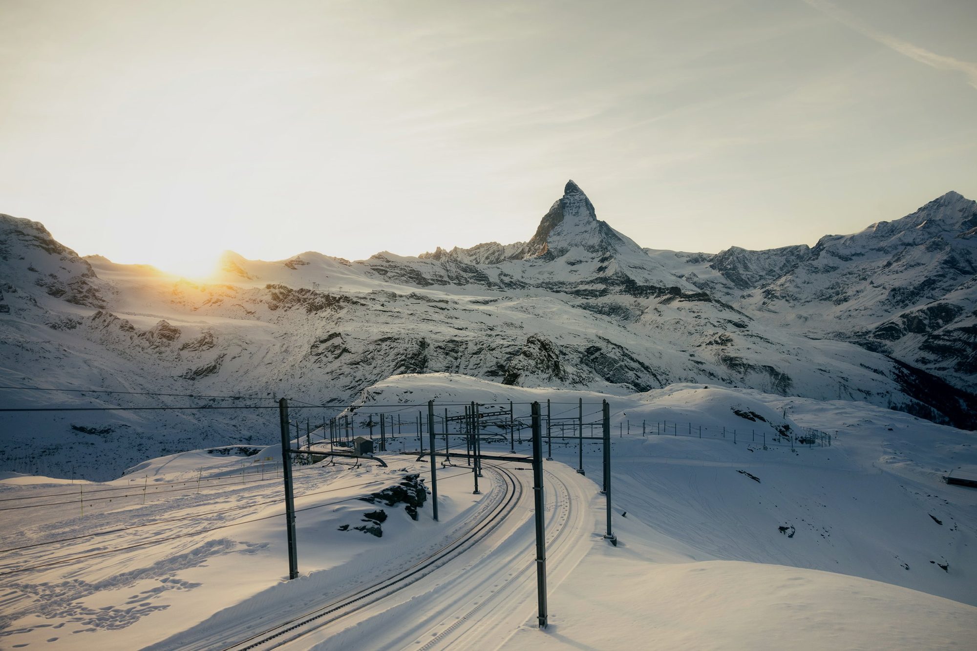 The Gornergrat railway under snow with the Matterhorn at sunset